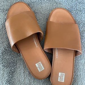 Tan FitFlop sandals.